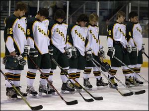 Clay High School's hockey team observes a moment of silence before the game against Southview High School at the Ice House. Last night was the first game since teammate Kyle Cannon was injured.