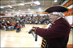 Michael Lieber, Sylvania town crier, reads a proclamation in honor of Southview's state football championship.