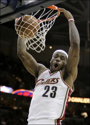 Cavaliers forward LeBron James dunks against the Raptors during the first quarter. James finished with 31 points and became Cleveland s career steals leader.