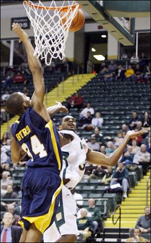 Toledo s Anthony Byrd , left, tries to swat away a shot from Wright State s Will Graham last night. Byrd had five points.