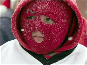 NBRE parade11p   12/06/2008     BLADE PHOTO/Lori King  Raymer football player Andrew Mierzejewski, 10, shields his face from the cold as he rides on his football team's float during annual Christmas parade in East Toledo, OH. His team is 16-0, which back to back undefeated seasons.