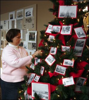 Jennifer Wenzel puts final touches on a Christmas tree in the Summerfield Petersburg Branch Library.