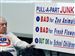 Daniel Kazmierczak makes his opinions known on a sign opposing the planned salvage operation in his neighborhood in South Toledo. The meeting turned contentious at times. 
