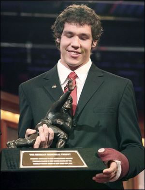 Oklahoma's Sam Bradford received 300 first-place votes, while Tim Tebow had 309 and Colt McCoy 266.