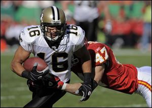 Saints wide receiver Lance Moore tries to shake free from Chiefs safety Jon McGraw on Nov. 16.