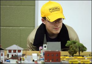 Slug: NBRN library18p               Date12/14/2008           The Blade/Amy E. Voigt       Location: Petersburg, Michigan  CAPTION:  Evan Manley, from Maumee, looks over a train set from Boo-Coo Trains during a host of activites for Christmas at the Petersburg Library including visits with Santa Claus and tours of decorated homes and businesses.