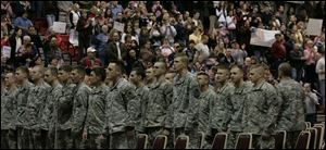 Members of Ohio Army National Guard s 1st Battalion, 148th Infantry are at attention as their return gets hearty cheers.
