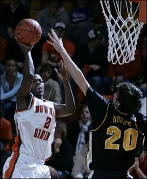 BG's Darryl Clements, goes over Towson's Brian Morris for two of his team-high 18 points. BELOW: 