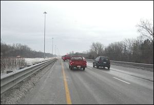 Drivers negotiating an ice-covered south-bound U.S. 23 at the Sylvania, Ave. overpass in Sylvania on Friday morning, Dec. 26, 2008