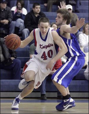 The Knights' Jake Szenderski (40) drives past Anthony Wayne's Jay Rezabek during the first quarter at the Knight Christmas Classic Friday night.