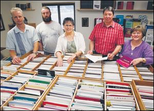 Dennis Blubaugh, second from right, with his staff, Michael Becker, left, Rick Jarvis, Jane Hamilton, and Jeanna Shade, in the choral music shop Musical Resources Ltd.