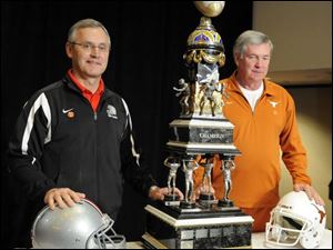 Either Ohio State coach Jim Tressel, left, or Texas coach Mack Brown will wind up with a rather large item for his school's trophy case after tonight's Fiesta Bowl in Arizona.