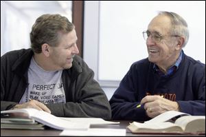 Reading student Henry Hartford, left, and his tutor, Bob
Niedzielski, share a laugh during their session at the main library in downtown Toledo.
