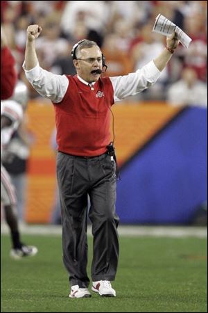 Ohio State coach Jim Tressel encourages his team. Tressel is 4-4 in bowl games.