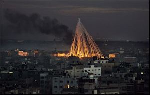 Smoke streaks into the sky over the outskirts of Gaza City as the Israeli operation continues and casualties mount. The United Nations says it has suspended delivery of all humanitarian aid.