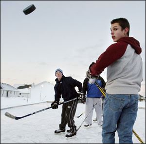 Mauder Louis Szilagyi, l6, right, watches as Mitchell Mauder, 14, sends a puck zooming past him during a pickup game.