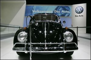 The classic Volkswagen Beetle featured in the automaker s commercials and print ads welcomes visitors to the VW section of the North American International Auto Show in Detroit.