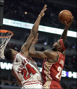 LeBron James commits an offensive foul against the Bulls  Tyrus Thomas.