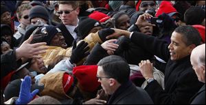 President-elect Barack Obama plunges into the crowd of well-wishers in Wilmington, Del.