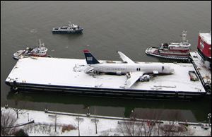 The ruins of what was US Airways Flight 1549 lays on a barge in the Hudson River. The plane will be moved to a New Jersey site, where it can be examined further.