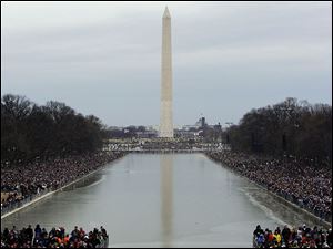 Crowds pack the mall in front of the Washington Monument as they await the start of the inaugural kickoff concert.
