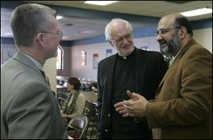 The Rev. Larry Clark, left, the Rev. Martin Donnelly, and Dr. S. Zaheer Hasan speak at the Islamic Center of Greater Toledo. 