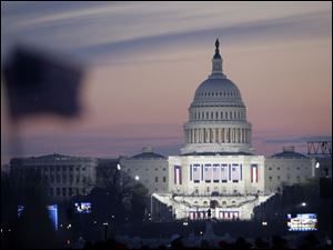 The sun rises on the U.S. Capitol and the already crowded National Mall on Inauguration Day as people continue to gather in anticipation of the swearing-in of President-elect Barack Obama on Tuesday, Jan. 20, 2009 in Washington. 