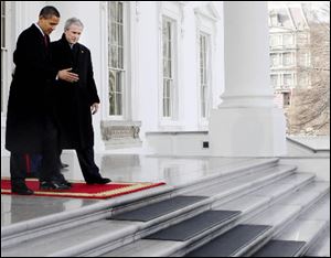 President Bush walks out with President-elect Barack Obama, on the North Portico of the White House before sharing the presidential limousine en route to Capitol Hill for inauguration in Washington on Tuesday.