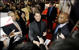 Tom Cruise greets fans in
South Korea, where he traveled
to promote his new
movie,  Valkyrie. 
