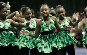 Semaj Lampton, 8, center, performs with the Positive Force Christian School of Dance. The group was among several performers and speakers who addressed the crowd of about 2,500 that gathered to pay their respects to civil-rights leader Marin Luther King, Jr., who was killed in 1968.