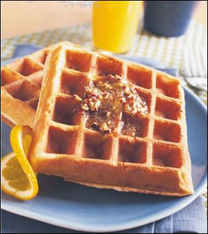 Serve Golden Waffles with pecans and maple syrup.
