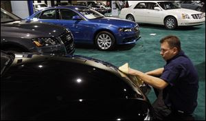 Chris Bopery polishes an Audi A5 in preparation for tomorrow's opening of the 2009 Toledo Auto Show in SeaGate Convention Centre in downtown Toledo.