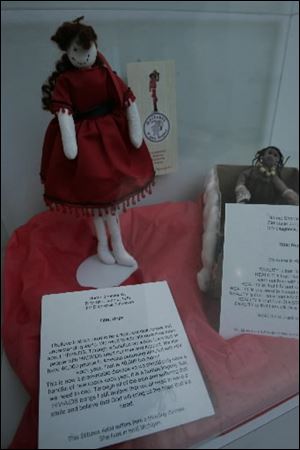 Personal stories accompany some of the dolls on display.