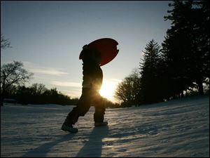 Slug: ROV sled22p Date:  01212009        The Blade/Andy Morrison       Location:  Toledo       Caption: Jocelyn Shook, 6, Toledo, makes another tip up the sledding hill as she and her family enjoy the late afternoon sun sledding at Ottawa Park, Wednesday, 01212009. Summary: