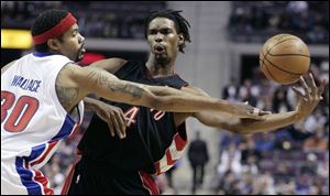 The Pistons  Rasheed Wallace fouls Chris Bosh, who led the Raptors with 19 points.