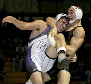 Southview senior Greg Isley, right, gets a standing cradle hold on Tyler Trautwein of Fremont Ross in the 189-pound title match at the Perrysburg Invitational Tournament. Isley won with a pin.