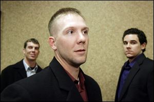 Clete Thomas, center, says he played injured the last three months. Behind him are Brent Clevlen, left, and Jeff Larish.