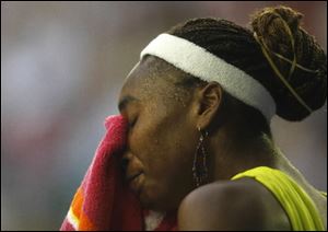 Venus Williams pauses before recommencing play against Carla Suarez Navarro of Spain during a women's singles match Thursday at the Australian Open.