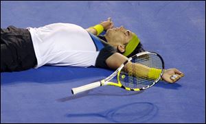 After playing five sets that lasted 4 hours, 22 minutes, Rafael Nadal celebrates his exhausting Australian Open victory. Roger Federer was emotional after failing to match Pete Sampras' Grand Slam record.
