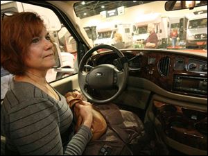 Sue Goldsmith, sitting in a Ford Cambria   one of about 100 RVs on display   tells her husband she could drive it.