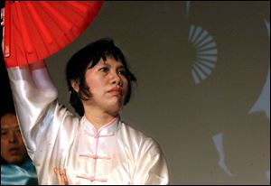 Jing Meyer performs a traditional Chinese dance with a fan during the 2009 Spring Festival put on by the Toledo Chinese community.