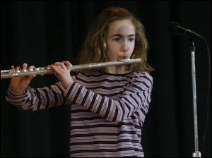 Flute player Ashlyn McIntyre, a fifth-grader, performs in the show.