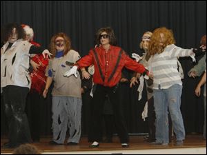 Teachers perform  Thriller,  with inclusion aide Heidi Linsenmeyer as Michael Jackson, in the finale of the Custer Elementary School talent show.  