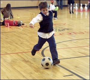 Winfield Vincent, 6, tries his foot at soccer to count to the number 100.
