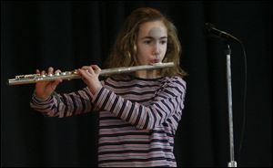 Flute player Ashlyn McIntyre, a fifth-grader, performs in the show.