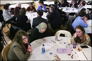 Michelle Niedermier, left, of Lucas County Job and Family Services, Sanaa Eid, and Rachel Davies discuss poverty at a forum conducted by the Ohio Association of Community Action Agencies. The group will gather information to send to Gov. Ted Strickland.