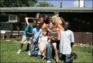 The Frisch family poses in front of their home on Edgedale Circle before it was demolished for the 'Extreme Makeover: Home Edition' show last year.