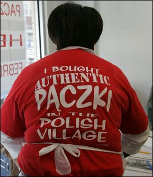 Annie Walker helps with the Polish Village paczki sale, which ends Tuesday. 
