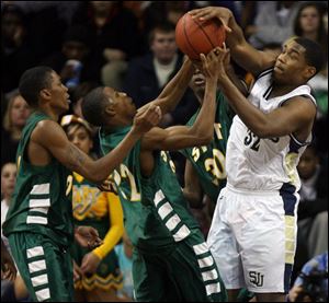 St. John s Tim Simmons (32) and Start s Anthony Henderson (22) battle for a rebound. Simmons had eight points for St. John s Henderson scored 20 points for Start.
<br>
<img src=http://www.toledoblade.com/graphics/icons/video.gif><b><font color=red> VIDEO</b></font color=red>: <a href=