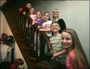 NBRS mom25p  In reverse birth order, from top:   Michael, Abigail, and Elizabeth, all 6; Sarah, 8, Austin, 10; and Olivia, 11. Mom Lee Ann Cox, 41, is at right of Sarah. The Cox family in their Weston, Ohio home on February 17, 2009.  The Toledo Mothers of Twins Club (TMOTC), a support group for mothers of multiples, has crowned Lee Ann Cox of Weston, Ohio as their 2009 Mother of the Year. The divorced mother has six childrenÑOlivia age 11, Austin age 10, Sarah age 8, and her triplets Elizabeth, Abigail, and Michael age 6.  The Blade/Jetta Fraser